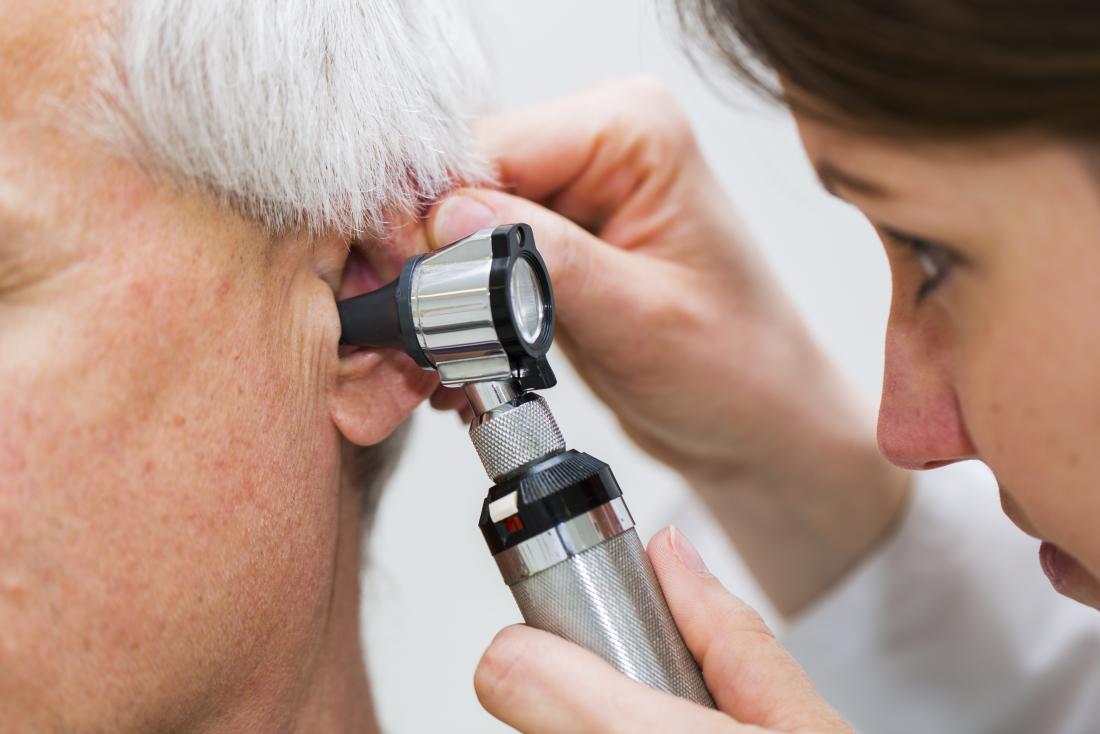 Otoscopy being performed by a healthcare professional to inspect ear health and remove wax